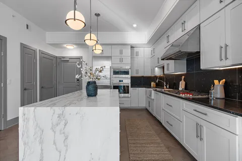 a kitchen with lots of counter top space cabinets and stainless steel appliances