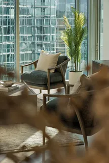 a living room with a couch and potted plant