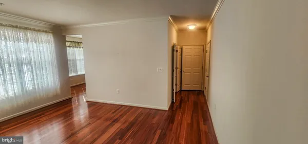 a view of hallway with wooden floor