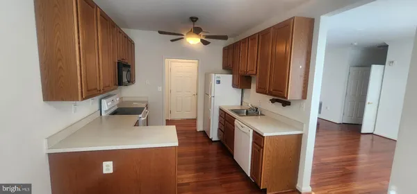 a kitchen with a sink a stove and a refrigerator