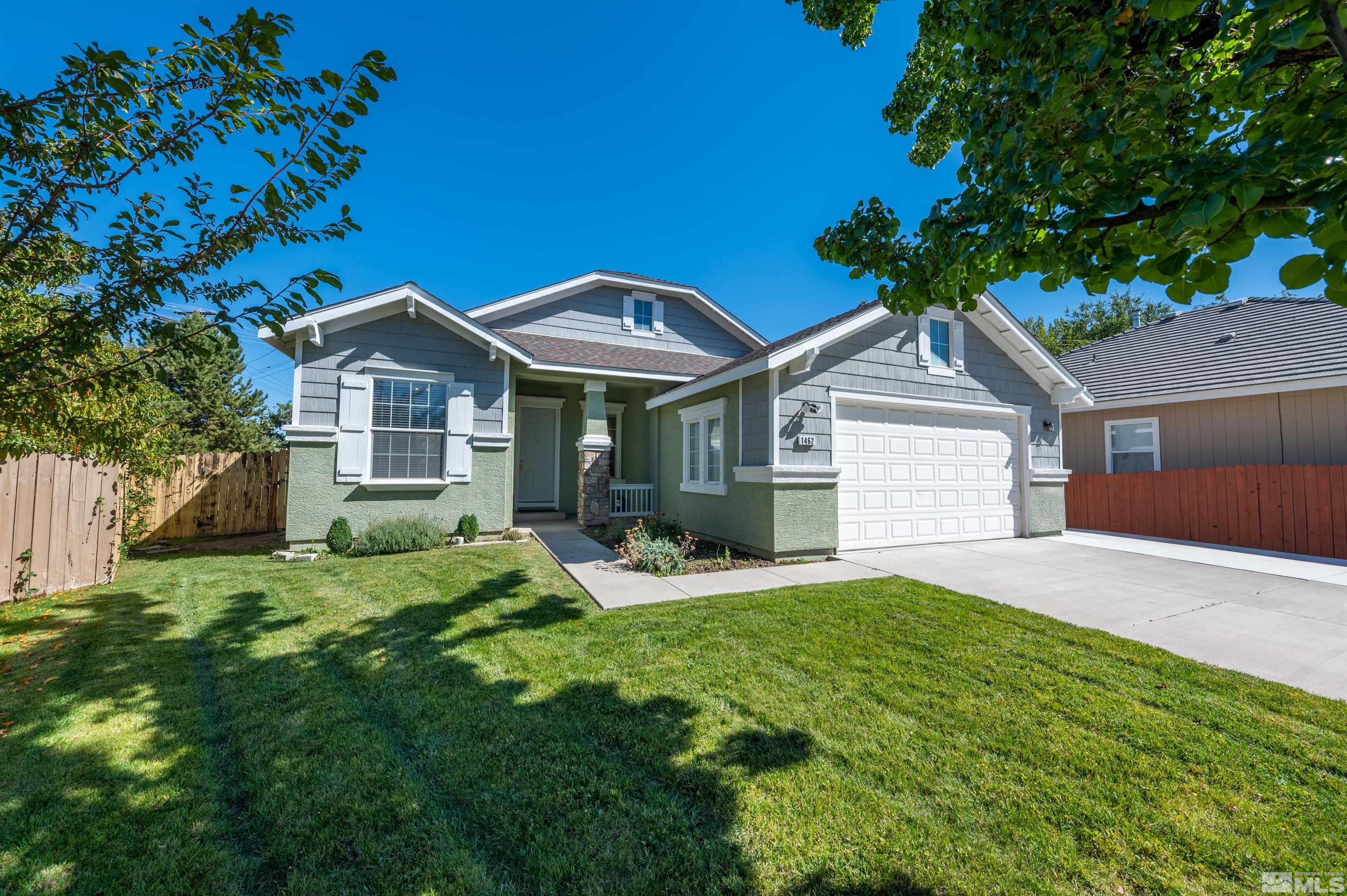 1462 Wessex Circle Reno, NV 89503 - Photo 1 of 40 a front view of a house with a yard and garage