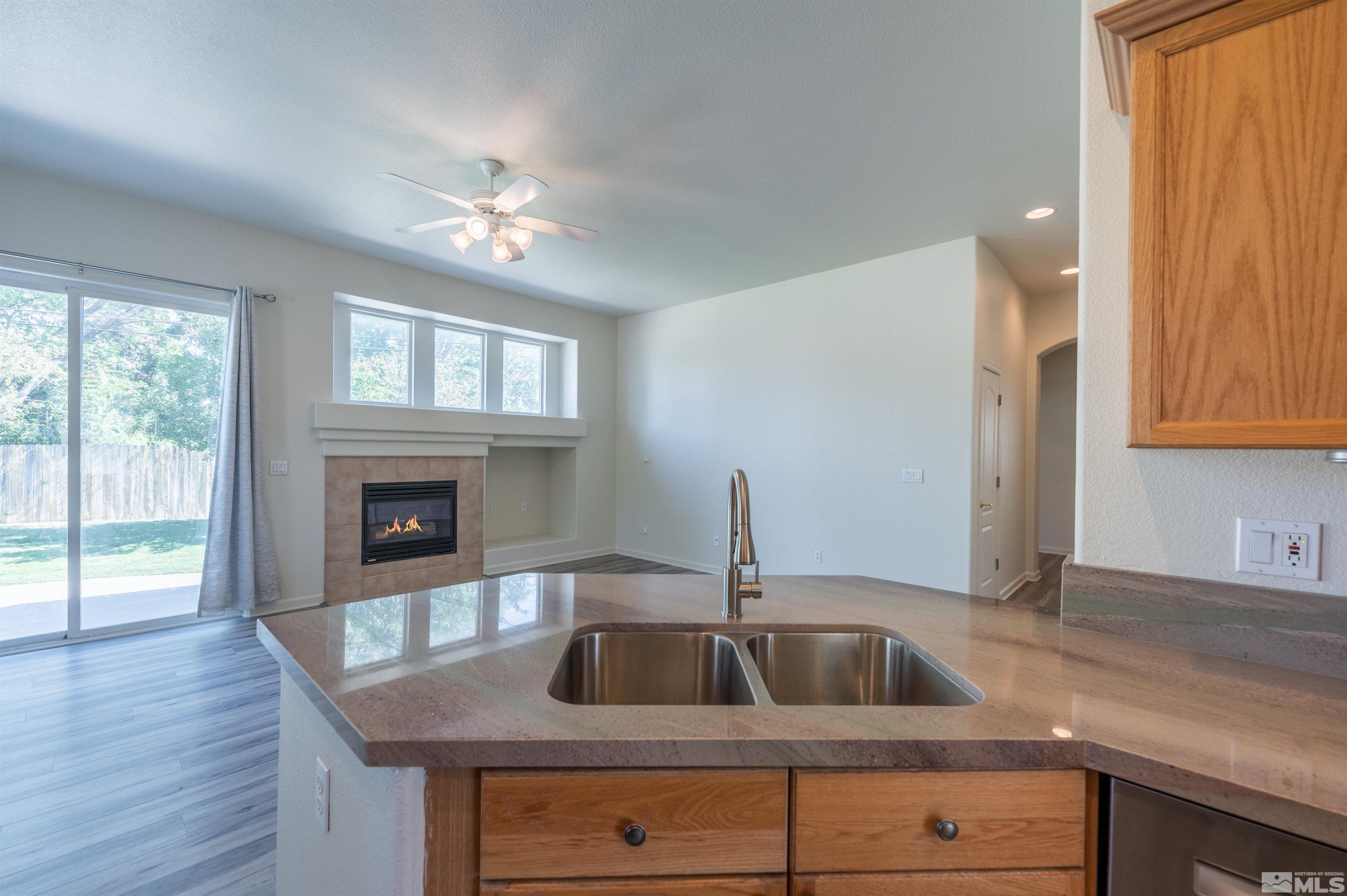 1462 Wessex Circle Reno, NV 89503 - Photo 12 of 40 a kitchen with a sink cabinets and wooden floor