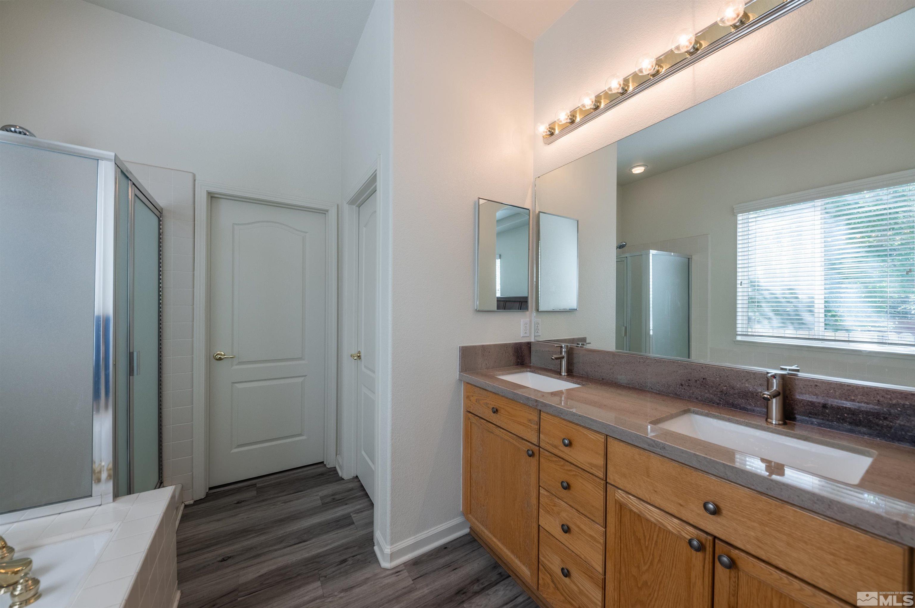 1462 Wessex Circle Reno, NV 89503 - Photo 16 of 40 a bathroom with a granite countertop sink and a mirror