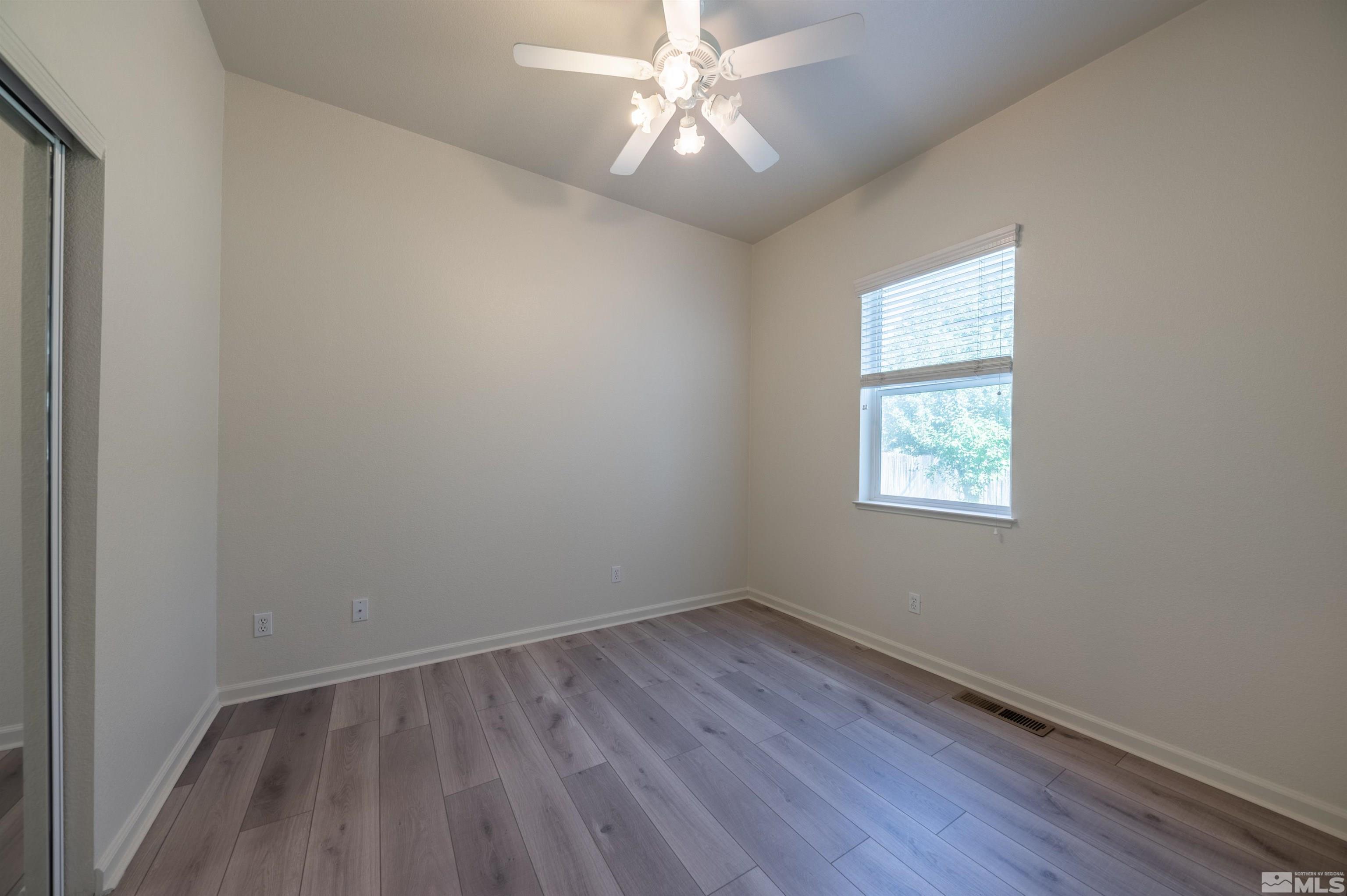 1462 Wessex Circle Reno, NV 89503 - Photo 18 of 40 an empty room with a window and wooden floor