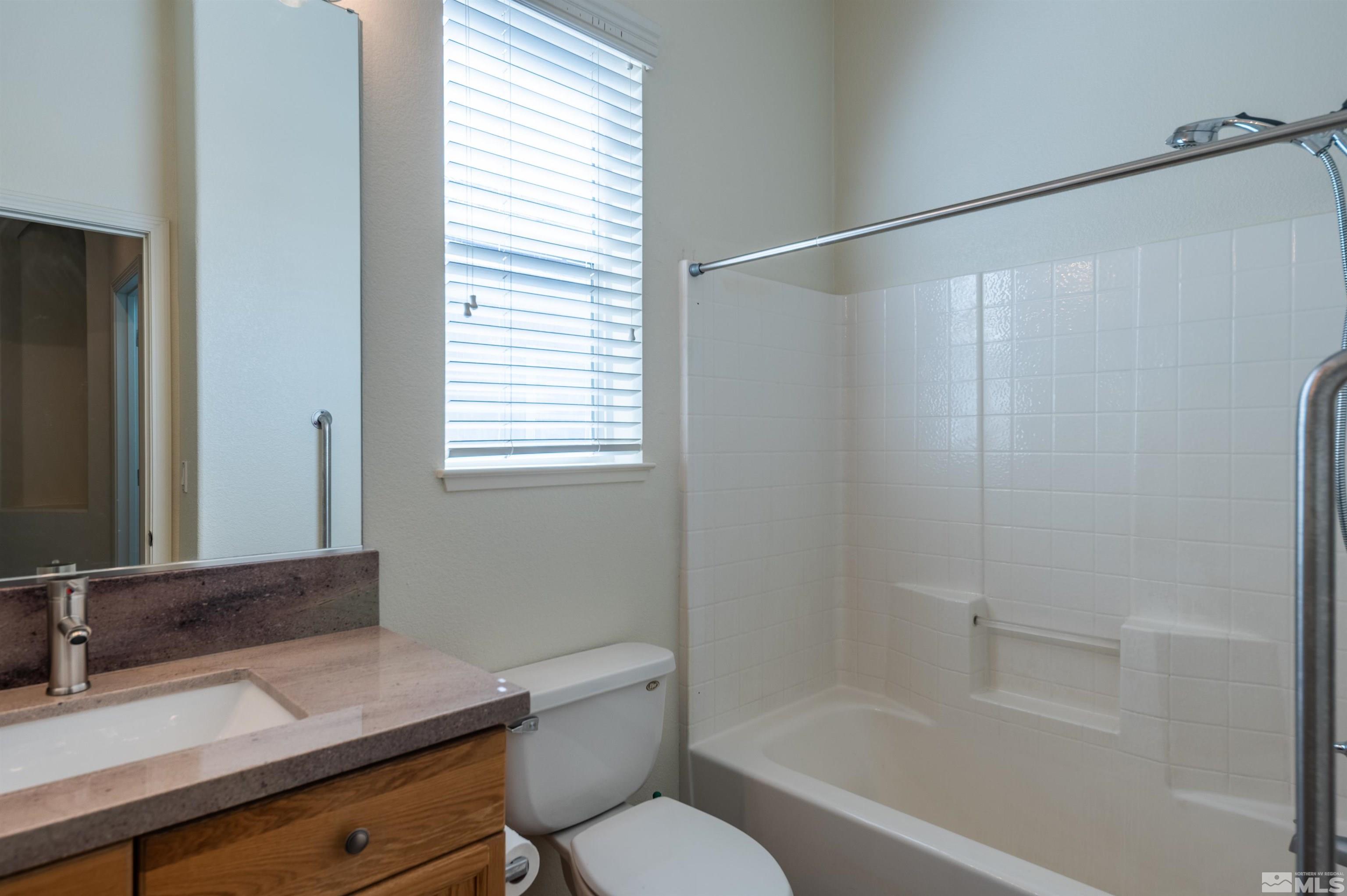 1462 Wessex Circle Reno, NV 89503 - Photo 19 of 40 a bathroom with a granite countertop sink toilet and shower
