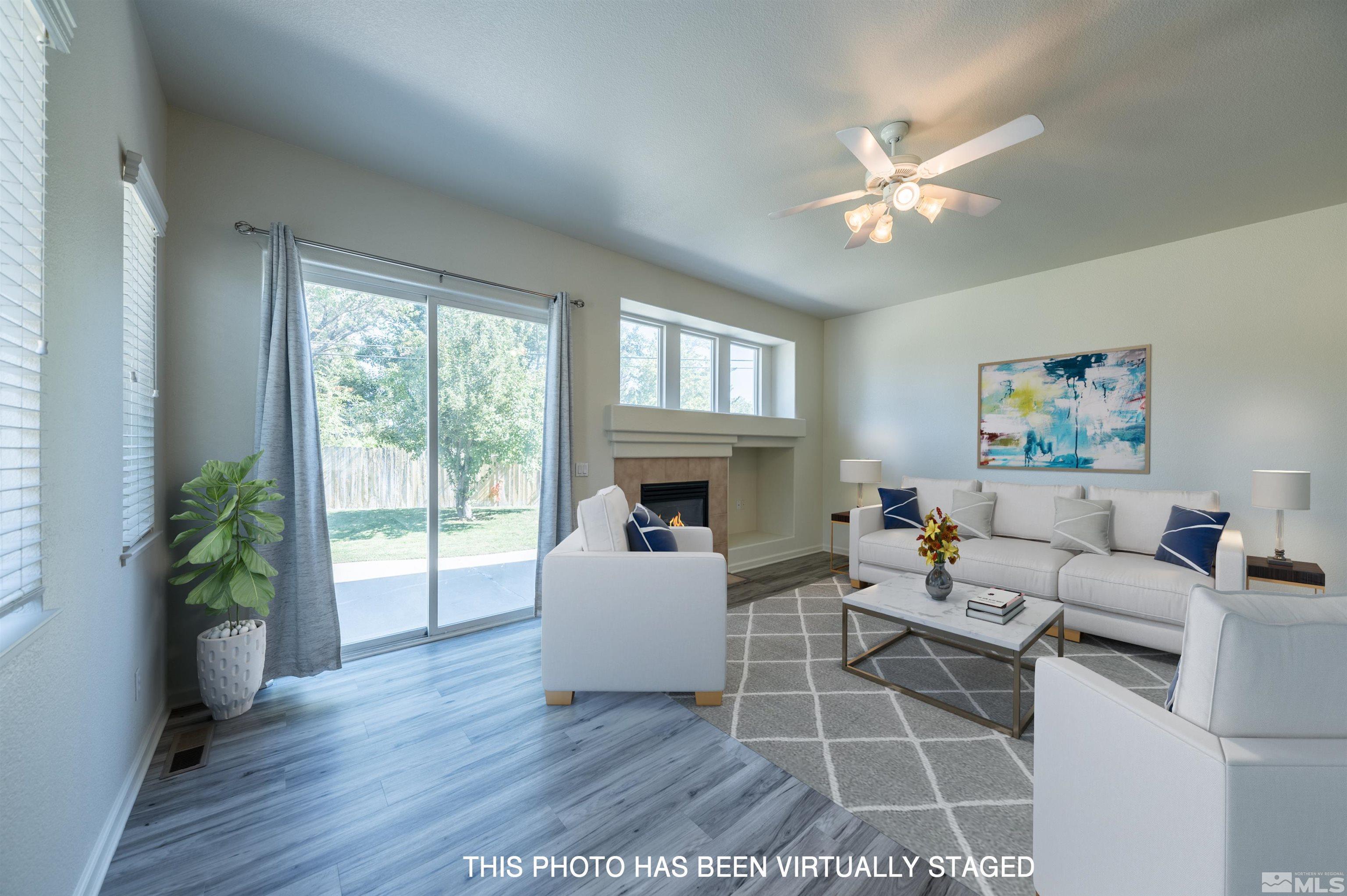 1462 Wessex Circle Reno, NV 89503 - Photo 5 of 40 a living room with furniture a flat screen tv and a large window