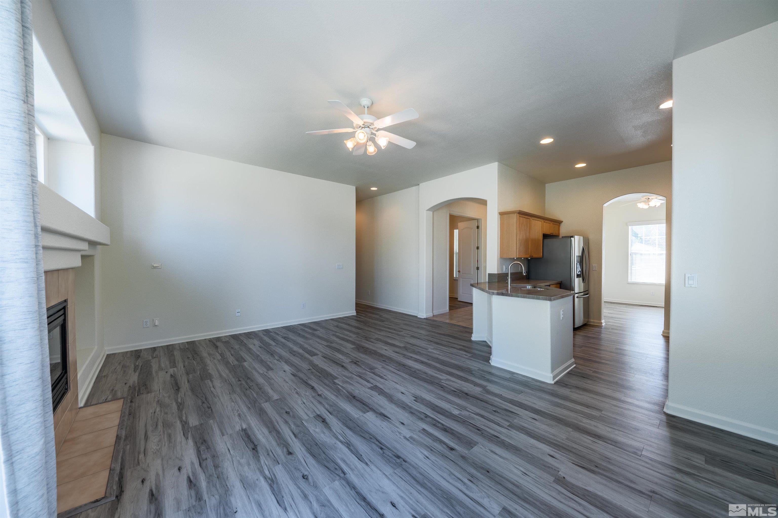 1462 Wessex Circle Reno, NV 89503 - Photo 6 of 40 a view of kitchen and an empty room with wooden floor