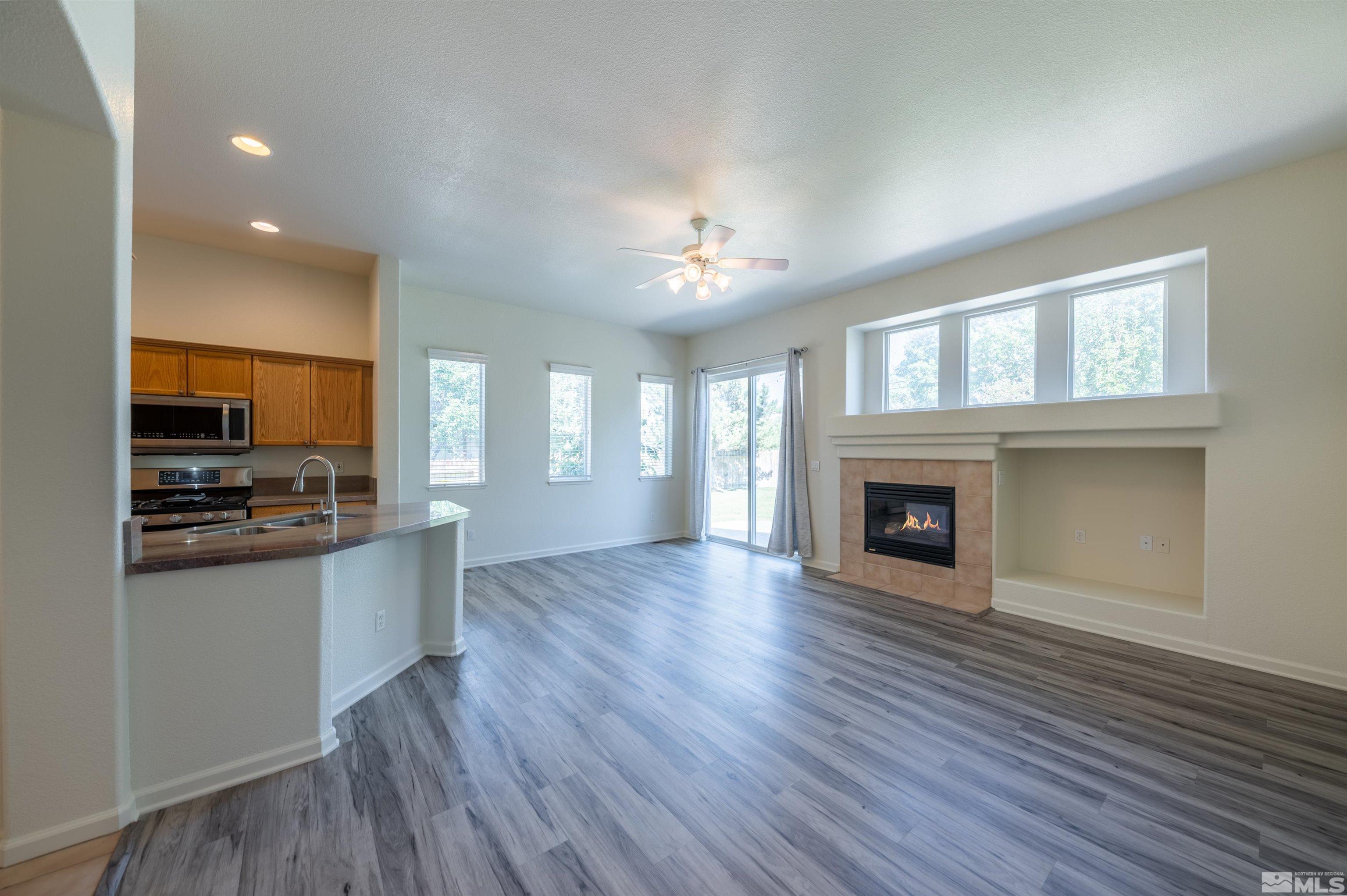 1462 Wessex Circle Reno, NV 89503 - Photo 8 of 40 a large kitchen with cabinets wooden floor and a fireplace