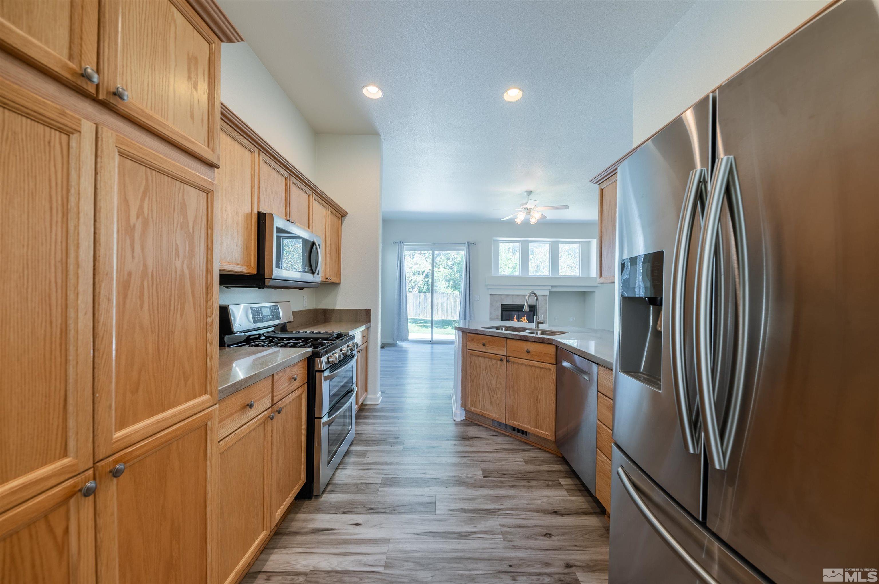 1462 Wessex Circle Reno, NV 89503 - Photo 10 of 40 a large kitchen with stainless steel appliances granite countertop a refrigerator a sink dishwasher a stove and a microwave oven on granite countertops