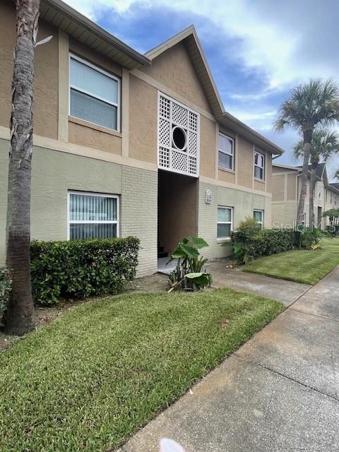 9817 Turf Way, Unit 8 Orlando, FL 32837 - Photo 1 of 1 a front view of house with yard and outdoor seating