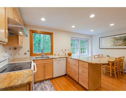 59 Rambling Road Sudbury, MA 01776 - Photo 8 of 24 a large kitchen with kitchen island a sink table and chairs