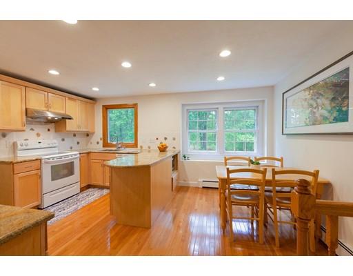 59 Rambling Road Sudbury, MA 01776 - Photo 10 of 24 a kitchen with a table chairs sink stove and cabinets