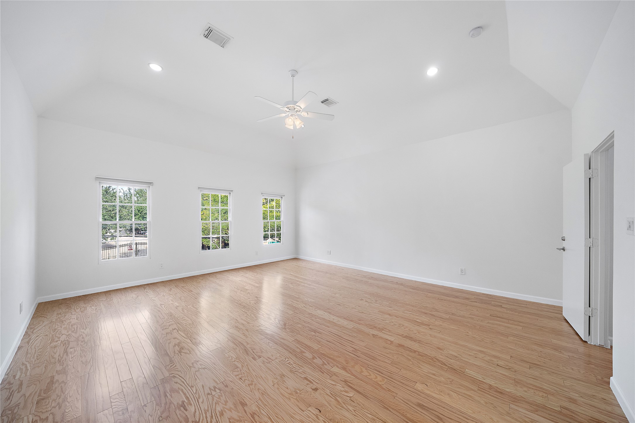 2437 North Boulevard Houston, TX 77098 - Photo 16 of 32 an empty room with wooden floor and windows