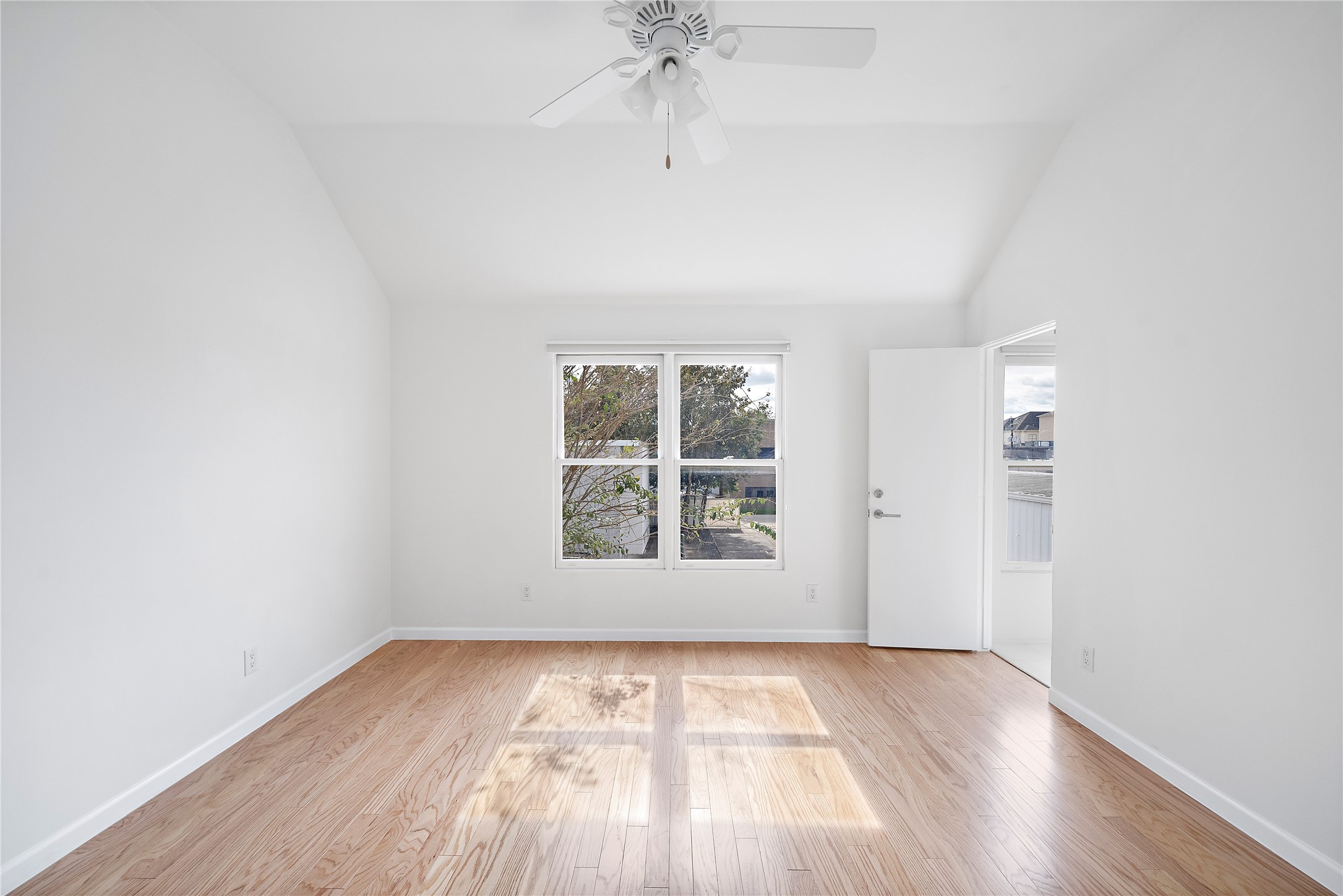 2437 North Boulevard Houston, TX 77098 - Photo 25 of 32 an empty room with wooden floor a ceiling fan and windows