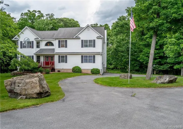 a front view of a house with a yard and porch