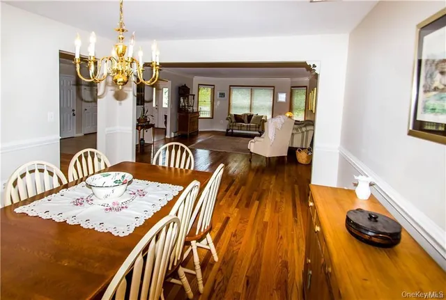 a dining room with furniture and a chandelier