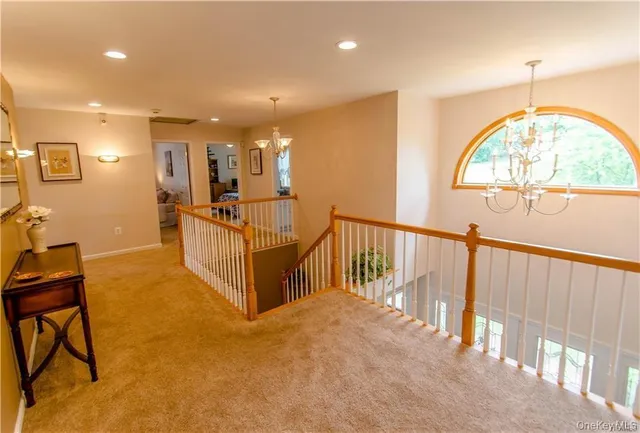 a view of a livingroom with furniture and staircase
