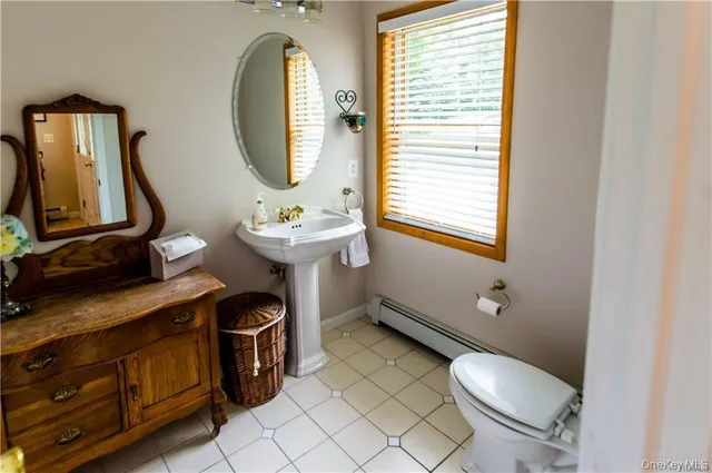 a bathroom with a sink mirror and toilet