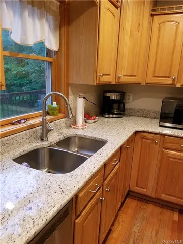 a kitchen with granite countertop a sink and a stove