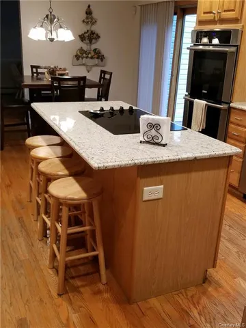 a dining table with chairs and wooden floor