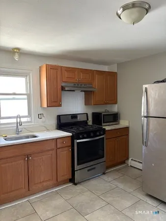 a kitchen with a stove sink and cabinets