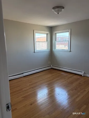 a view of a room with wooden floor and window