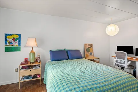 a bedroom with a bed and a lamp on table