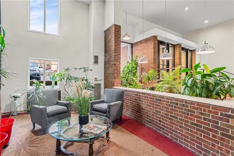 a balcony with furniture and a potted plant