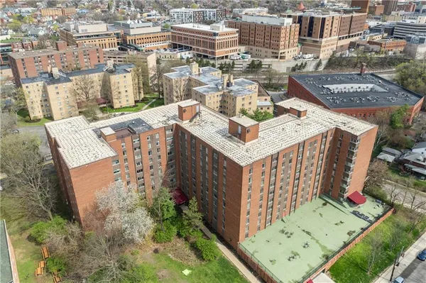 an aerial view of a residential building with an outdoor space