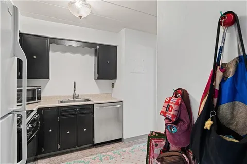 a view of a kitchen with appliances and a sink