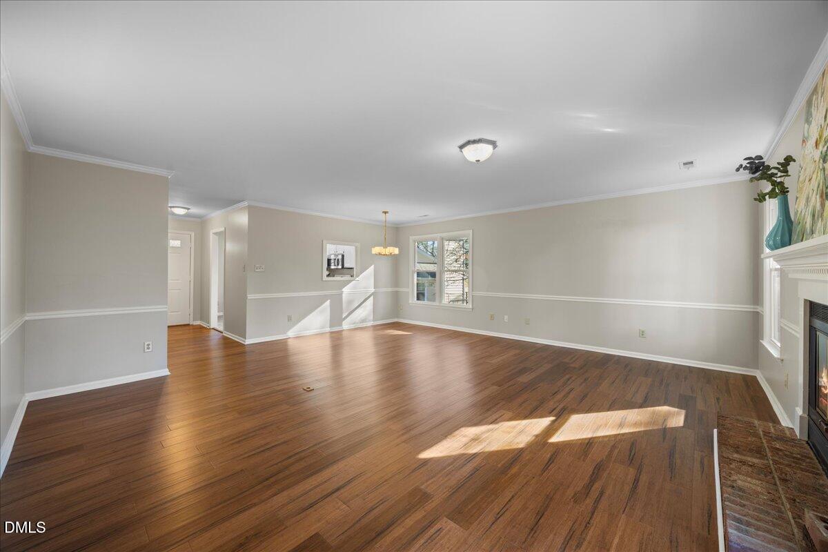 1511 Hemphill Drive Raleigh, NC 27609 - Photo 13 of 37 a view of an empty room with wooden floor and a window