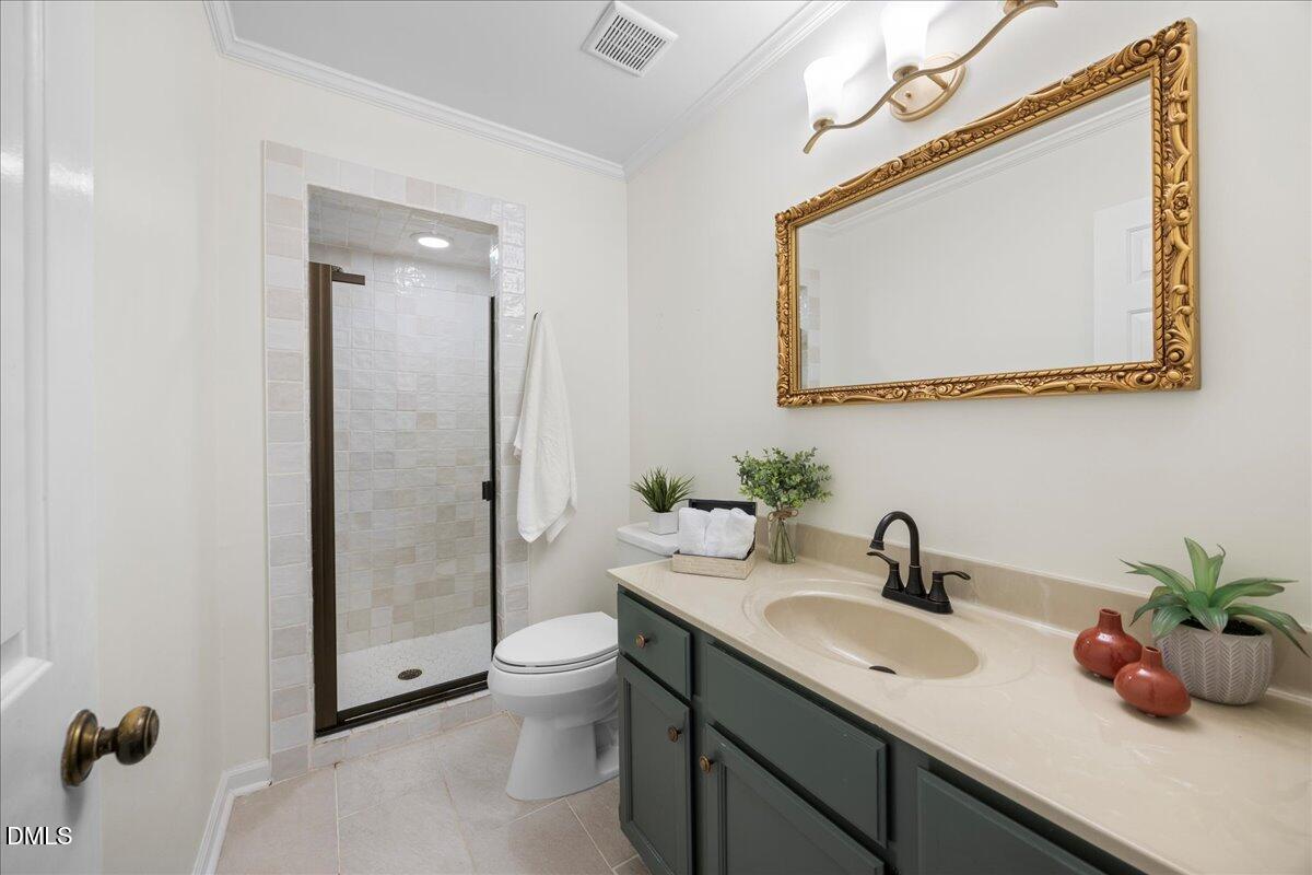 1511 Hemphill Drive Raleigh, NC 27609 - Photo 17 of 37 a bathroom with a toilet sink and mirror