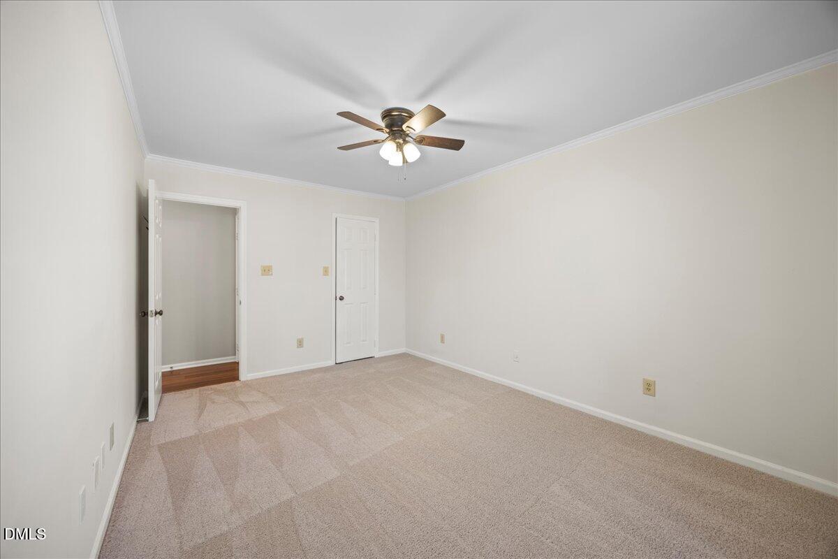 1511 Hemphill Drive Raleigh, NC 27609 - Photo 21 of 37 an empty room with a chandelier fan and windows