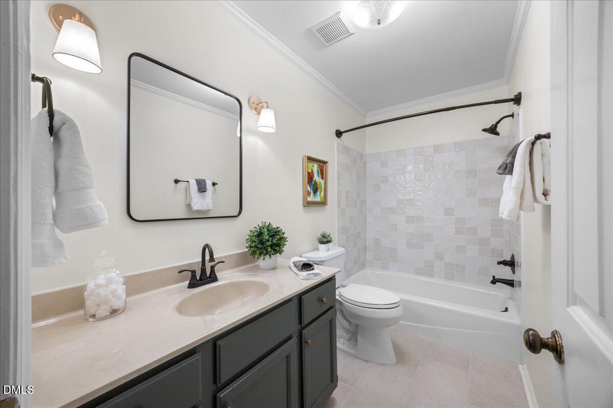 1511 Hemphill Drive Raleigh, NC 27609 - Photo 22 of 37 a bathroom with a double vanity sink toilet mirror and shower