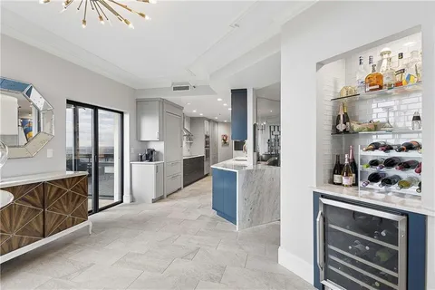 a large kitchen with stainless steel appliances lots of counter space and a sink