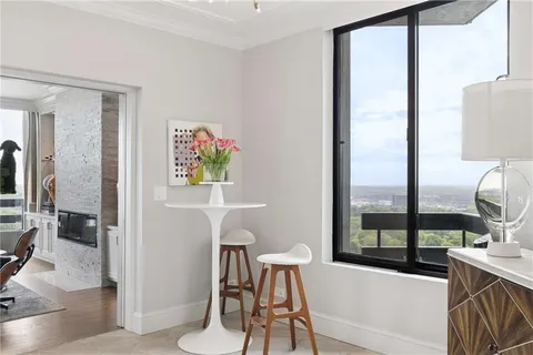 a living room with patio furniture and a flat screen tv