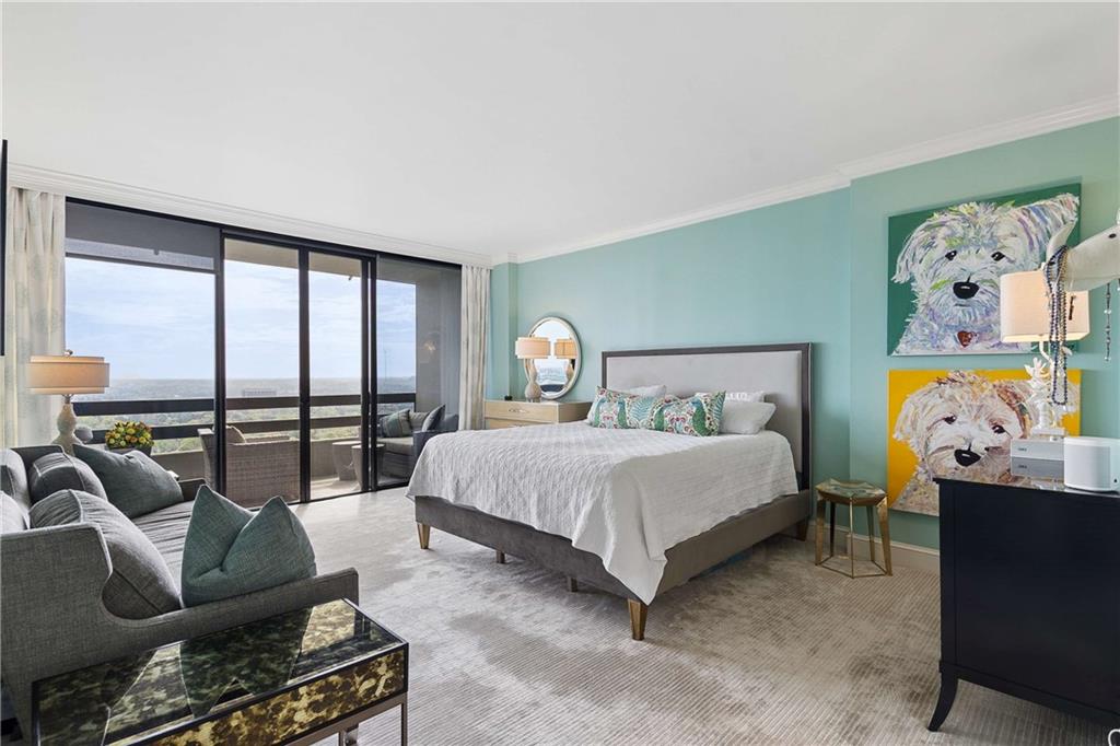 2660 Peachtree Road Northwest, Unit 34F Atlanta, GA 30305 - Photo 32 of 58 a spacious bedroom with a bed and glass window