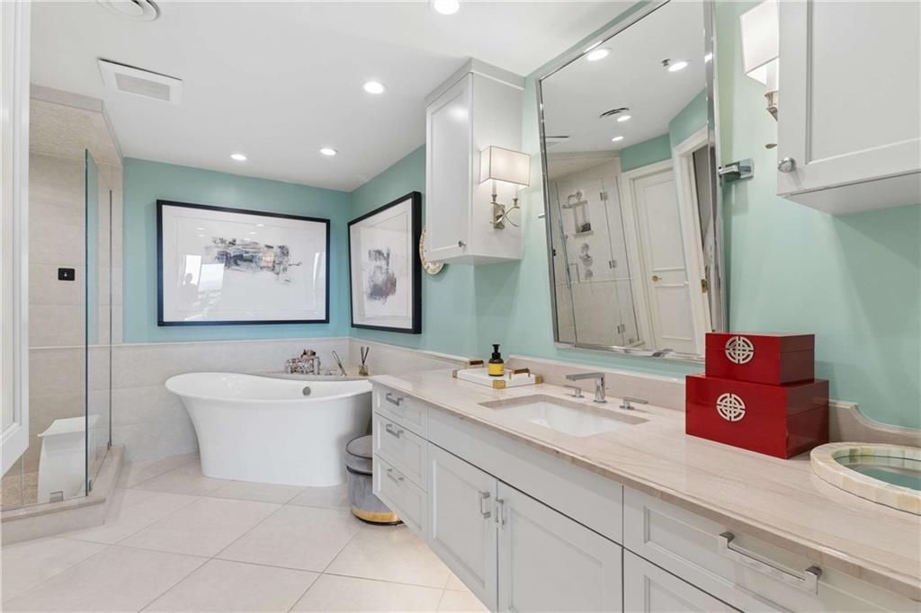 2660 Peachtree Road Northwest, Unit 34F Atlanta, GA 30305 - Photo 35 of 58 a bathroom with a double vanity sink mirror and bathtub
