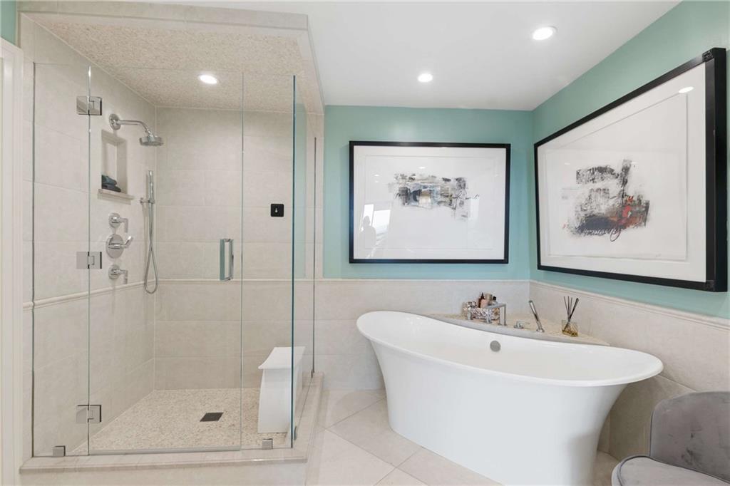 2660 Peachtree Road Northwest, Unit 34F Atlanta, GA 30305 - Photo 36 of 58 a bathroom with a bathtub and a shower