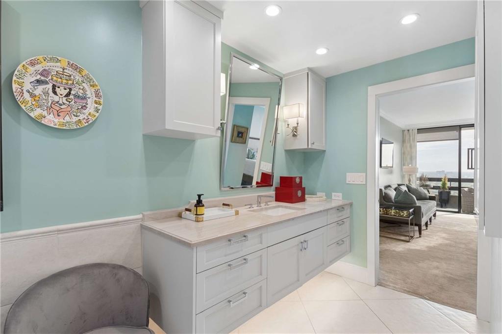 2660 Peachtree Road Northwest, Unit 34F Atlanta, GA 30305 - Photo 37 of 58 a bathroom with a sink and a mirror