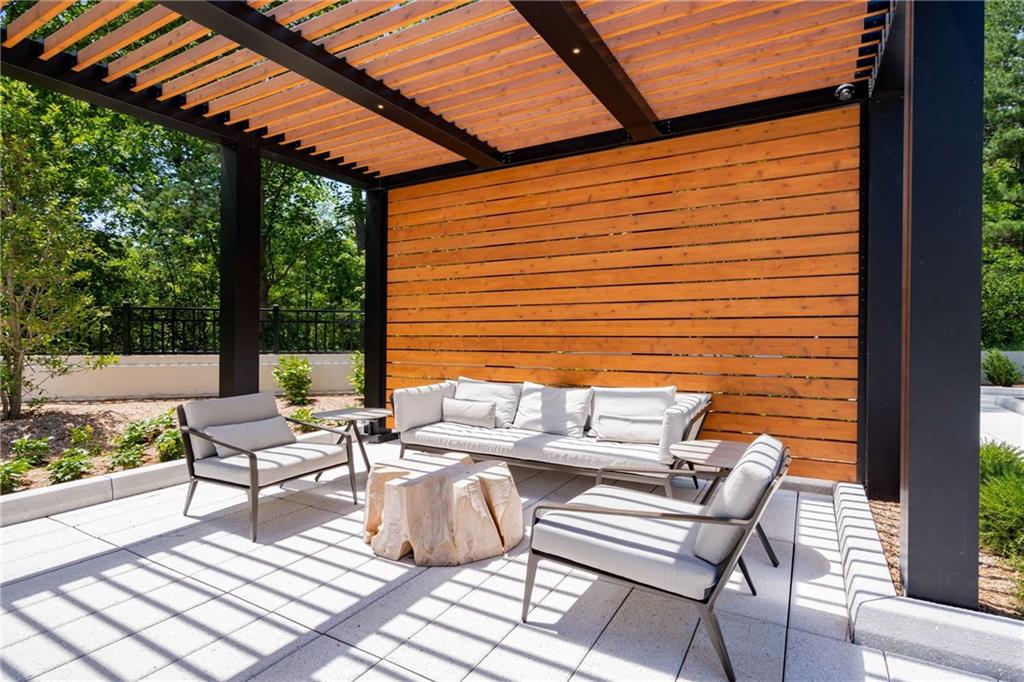 2660 Peachtree Road Northwest, Unit 34F Atlanta, GA 30305 - Photo 50 of 58 a view of a patio with couple of chairs and a fire pit