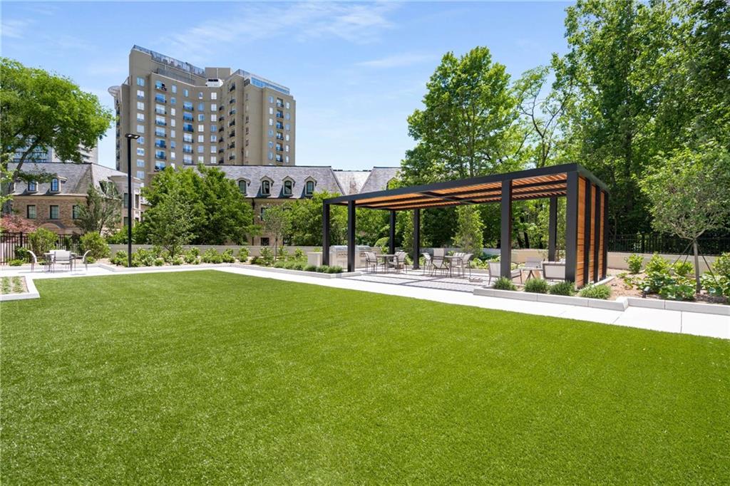 2660 Peachtree Road Northwest, Unit 34F Atlanta, GA 30305 - Photo 51 of 58 a view of building with yard and trees in the background