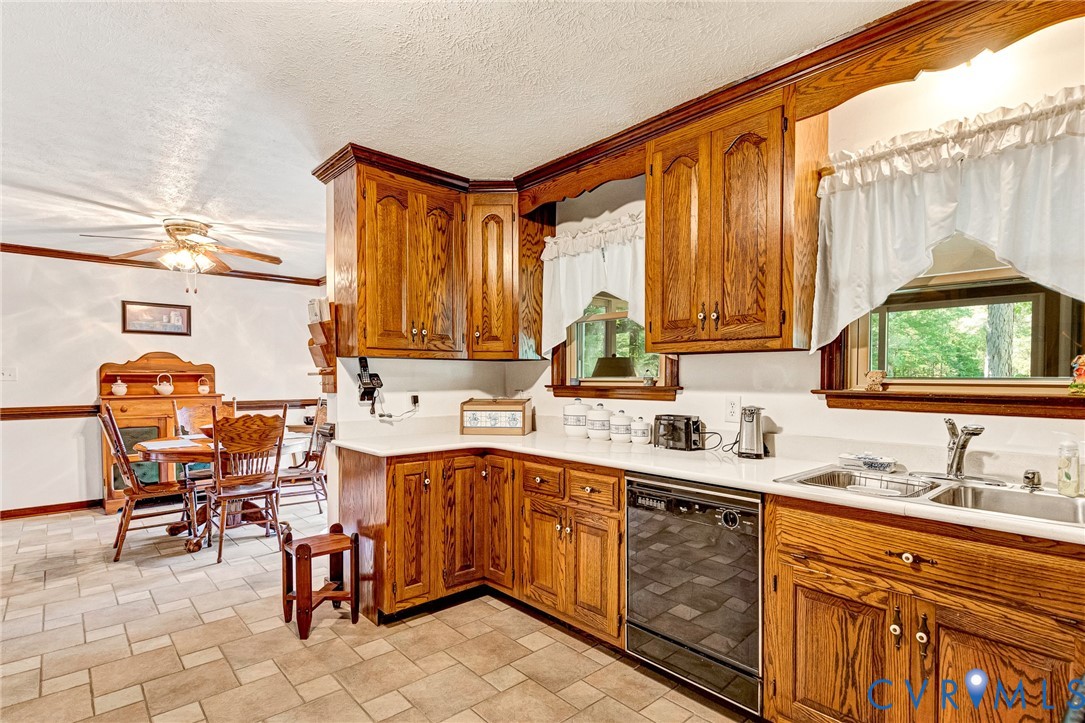 11516 Doswell Road Doswell, VA 23047 - Photo 11 of 50 a kitchen with a sink stove and chairs