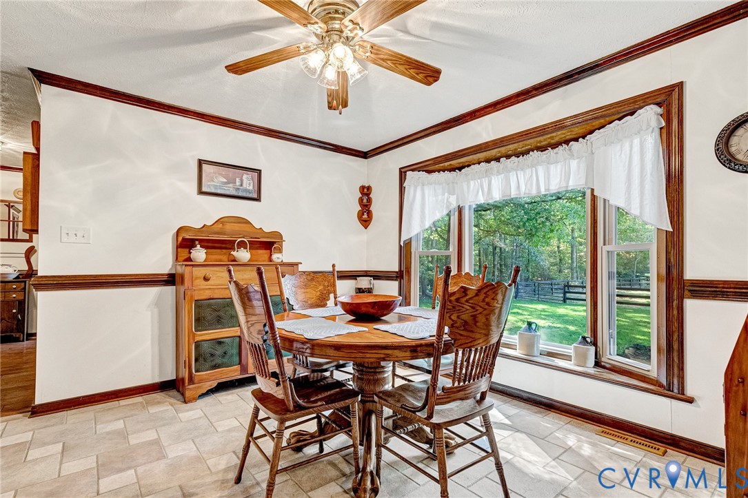 11516 Doswell Road Doswell, VA 23047 - Photo 13 of 50 a dining room with furniture a chandelier and a large window
