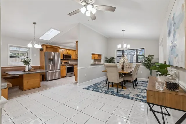 an empty room with windows and ceiling fan