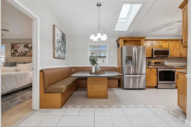 a front view of a house with a yard and potted plants