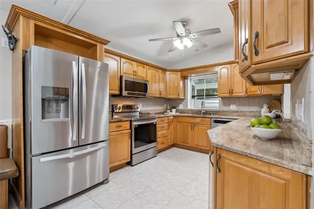 an aerial view of residential houses with outdoor space and parking