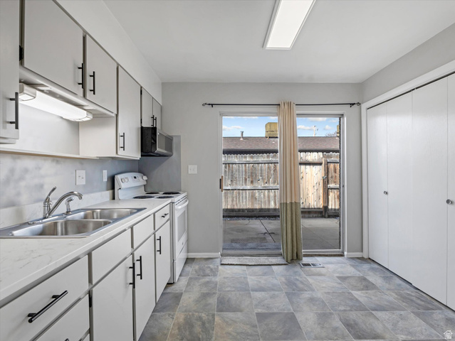 1478 North 75 West, Unit AD Sunset, UT 84015 - Photo 8 of 26 Kitchen featuring electric stove, light countertops, and stone finish flooring