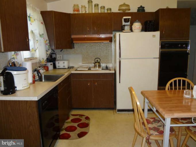 4740 Byron Road Baltimore, MD 21244 - Photo 2 of 12 a kitchen with stainless steel appliances granite countertop a sink a refrigerator and a stove