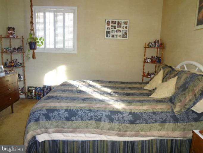 4740 Byron Road Baltimore, MD 21244 - Photo 7 of 12 a bedroom with a bed and a window